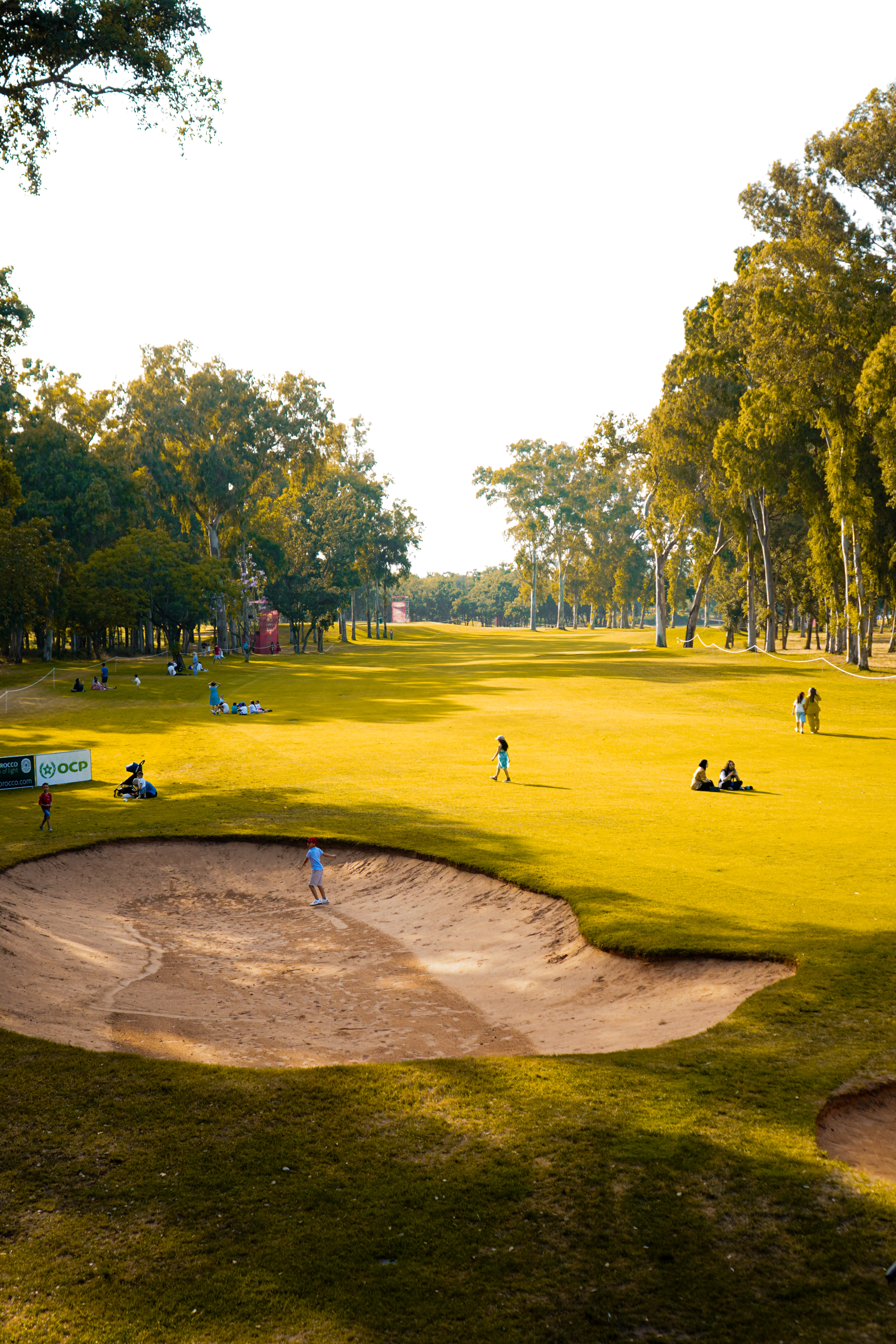 Golf course bunker with spectators